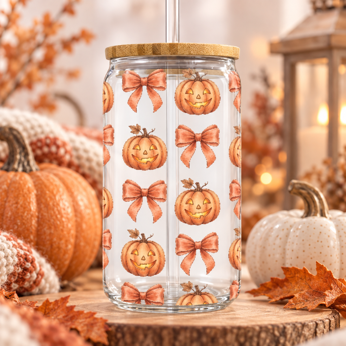 Pumpkin and Bow Halloween glass can with bamboo lid and straw in a cosy autumn setting