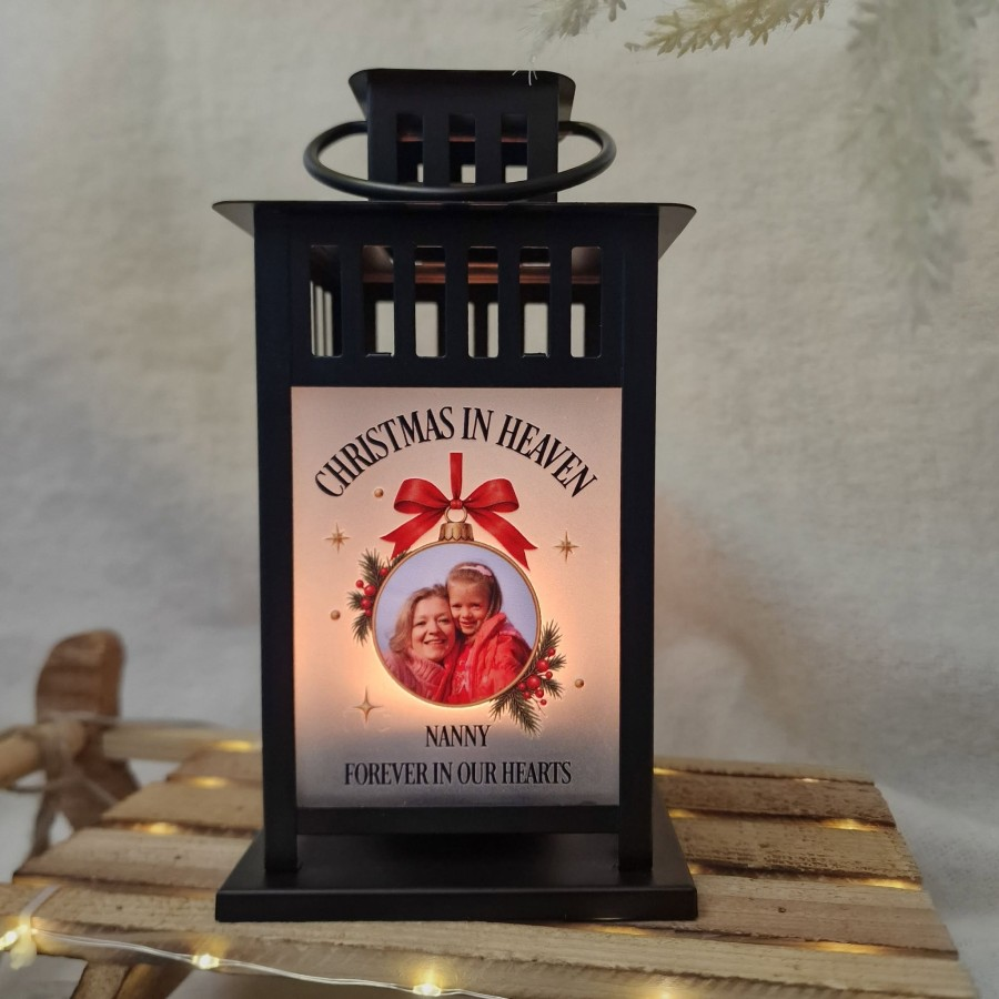Personalised Christmas in Heaven memorial lantern glowing with a red bow and treasured family photograph